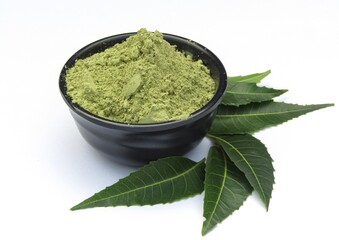 Neem leaves powder in a bowl isolated on white background 