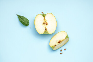Pieces of ripe apple on color background