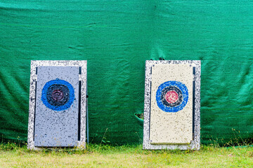 Homemade Styrofoam archery targets in front of green target net.
