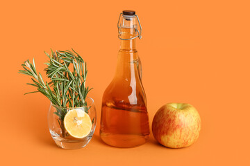 Bottle of fresh apple juice and glass with rosemary on color background