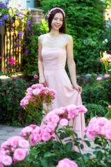 Young woman in pink dress outdoors - 553100833