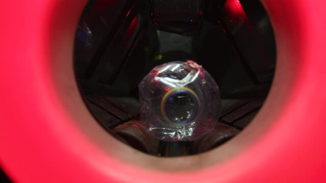 Close up putting and scanning plastic bottle in recycling bin
