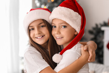 Little children in pajamas hugging at home on Christmas eve, closeup