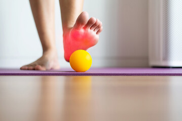 Woman massaging with rubber ball on feet,Foot soles massage for plantar fasciitis