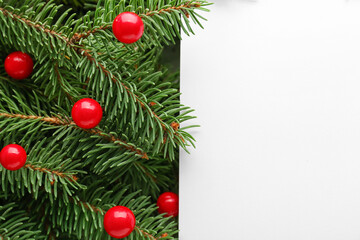 Blank paper sheet on Christmas branches with balls, closeup