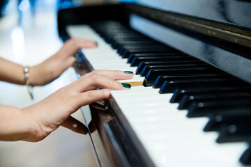 Woman hands on the piano keys