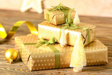 Stack of beautiful Christmas gifts and decorations on wooden table