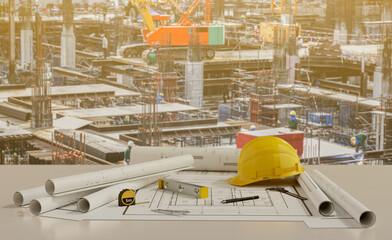 Blue prints with tool and  building under construction background.3D rendering