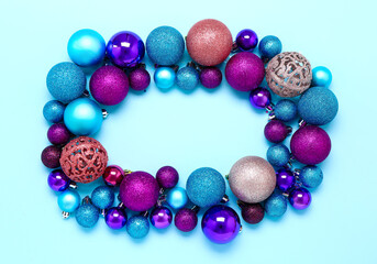 Frame made of beautiful Christmas balls on blue background