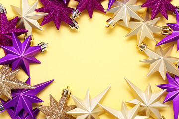 Frame made of beautiful Christmas decorations on yellow background, closeup