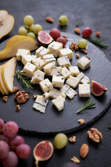 Sliced Traditional Italian Gorgonzola cheese on stone seving board