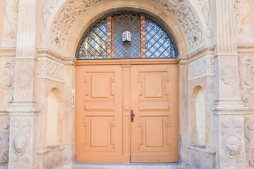 A brick building in the historic section of Wroclaw Poland. With charming colorful wooden doors.