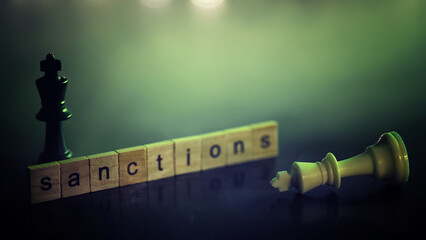 word sanctions spelled in letters on table made of wooden block letters with dramatic lighting and...