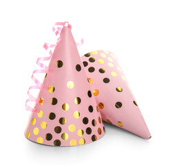 Pink party hats with glitter and confetti on white background