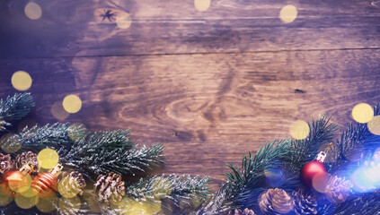 Obraz na płótnie Canvas Christmas or New Year dark wooden background, Xmas board framed with season decorations, space for a text