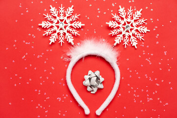 Beautiful Christmas headband, bow and sequins on red background