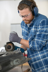 man mechanical worker repairing with electric grider