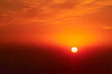A red sun in the sunset sky, a summer landscape. Evening sky in hot sunlight