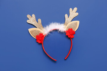 Beautiful Christmas reindeer horns headband on blue background