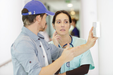 Fototapeta premium male technician is fixing device in hospital
