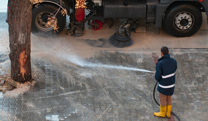 Municipal teams cleaning the streets after the flood - Municipal cleaning vehicle cleans the streets