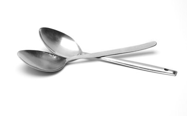 Two old used silver spoons on isolated white background