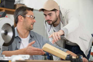 Fototapeta premium carpenter with apprentice in training period