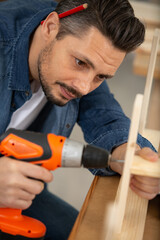 man during electric drill screwdriver