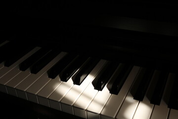 Fototapeta na wymiar Sunlight on Piano, keyboard close up instrument playing music, practing and celebrate. Hope