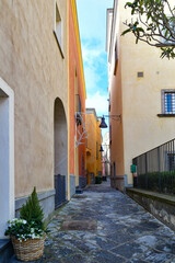 Fototapeta na wymiar A narrow street in Pozzuoli, a town facing the sea near Naples in Italy. 
