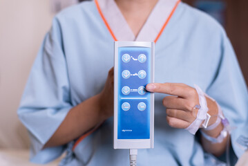 Patient women hands using remote control for adjust level sickbed at hospital