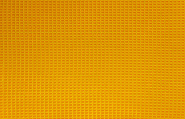 Orange abstract background. Natural cotton waffle fabric, cloth texture. Top view, close up.