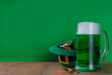 Beer glasses with leprechaun hat, shamrock clover leaves, traditional decorations for St. Patrick's...