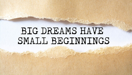 Big Dreams Have Small Beginnings word written under torn paper.
