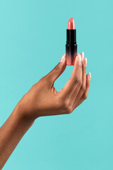 Black female hand showing lipstick