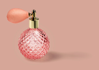 Pink vintage perfume bottle with pump in studio