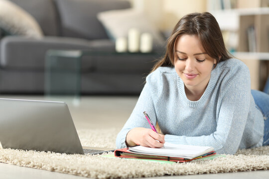 Teen studying on the floor at home