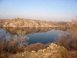 Fototapeta na wymiar Spring March landscape with river and rocks