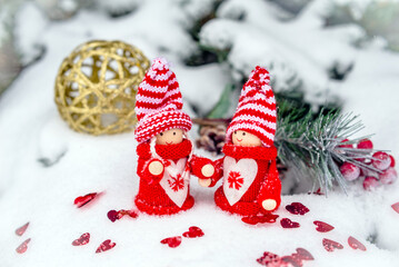 Christmas toys stand on the branches of a snow-covered fir tree

