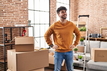 Young hispanic man smiling confident standing at new home