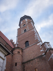 Fototapeta na wymiar brick made tower and cloudy sky in krakow old city