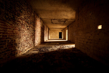 empty hallway with stone walls in a lost place