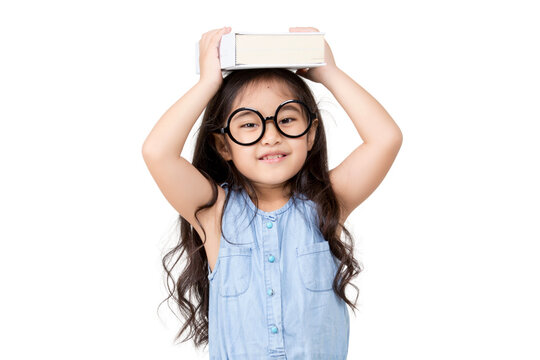 Portrait of lovely little Asian girl thinking and put a book on top with copy space isolated on transparent background, PNG file format.