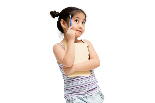 Portrait with copy space empty place of thoughtful little Asian girl having paper and pencil in hands looking up, writer waiting for muse isolated on transparent background, PNG file format.