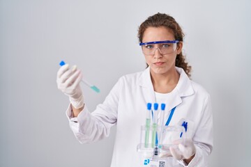 Young caucasian scientist woman working with laboratory samples skeptic and nervous, frowning upset because of problem. negative person.