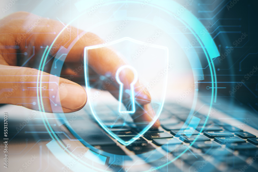 Poster Close up of businessman hand using laptop keyboard with glowing secure padlock shield hologram on blurry background. Protection, safety and internet concept. Double exposure.