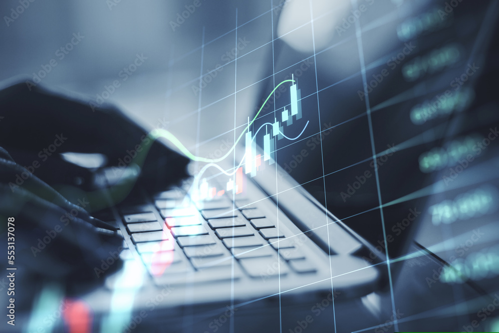 Poster close up of backlit hands using laptop on desktop with glowing business forex chart hologram and gri