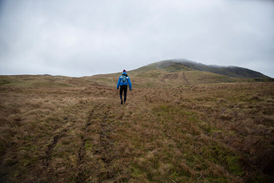 Man spending leisure time walking on hill