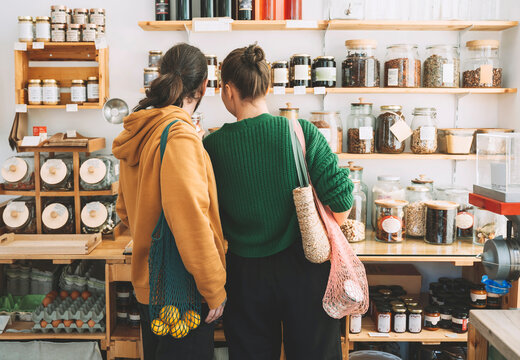 Couple with mesh bags shopping in zero waste store