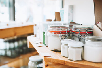 Cosmetic product jars arranged in shelf at zero waste shop